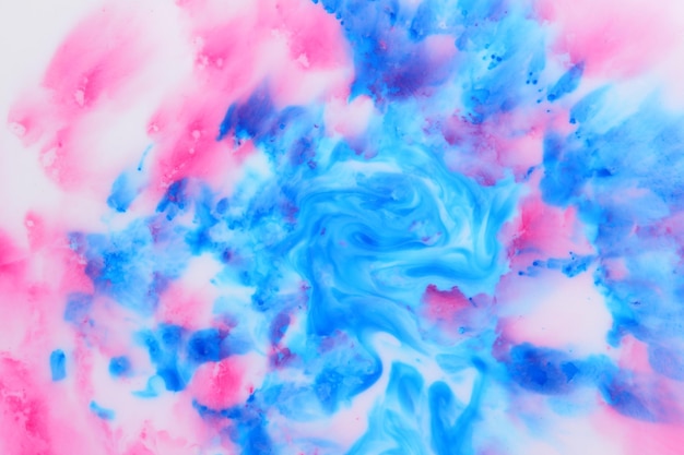 Abstract liquid background Fluid art of pink blue Pink and blue stains on white liquid