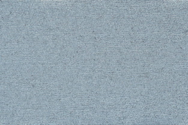 Abstract macro texture of damp synthetic fabric for a background of pale blue color