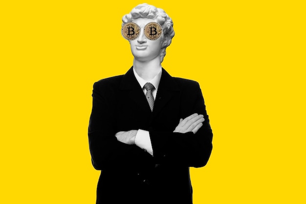 Abstract modern collage. The man with the plaster head of David Smiling businessman standing with arms folded with bitcoin eyes isolated on yellow background