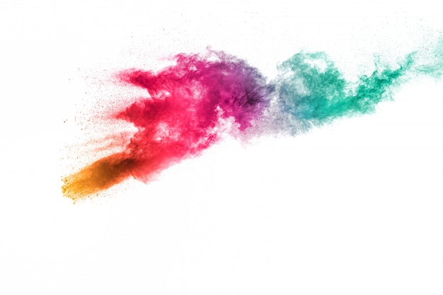 Abstract multi color powder explosion on white background.Freeze motion of dust particles splash.