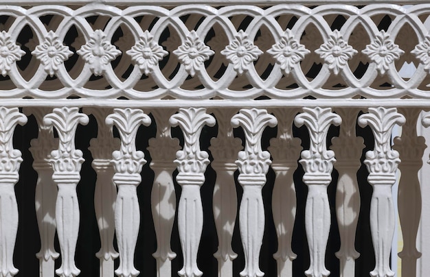 Abstract ornament decorative pattern of vintage white cast iron sliding fence gate in Roman style