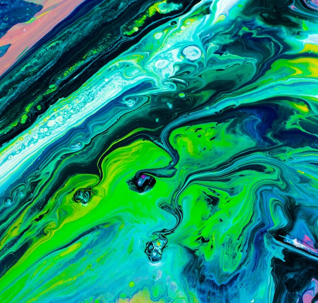 Abstract painting background made of liquid acrylic with fluid art technique with colorful bright colors.