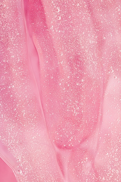 Abstract pink liquid background paint splash swirl pattern and water drops beauty gel and cosmetic t...