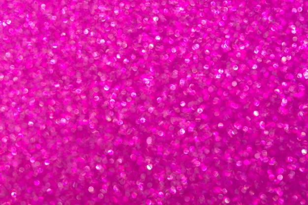 Abstract pink magenta background with unfocused bokeh. Fashionable bright shiny color of femininity