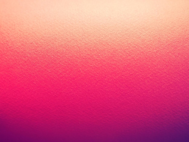 Abstract pink and purple background with texture Closeup of paper surface with light and color gradient Side lighting Vivid purple or magenta shade