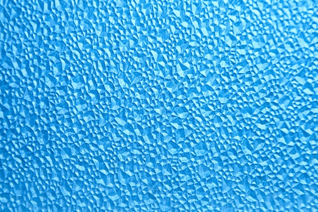 Abstract polygonal pattern on a blue plastic window on the lumen