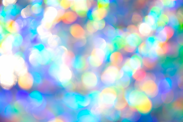 Abstract radiant festive backdrop texture image of holographic bokeh iridescent metallic foil