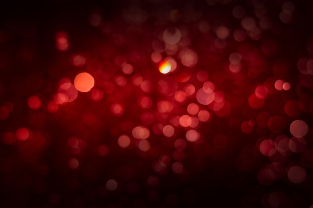 Abstract red background with soft blur bokeh light effect.