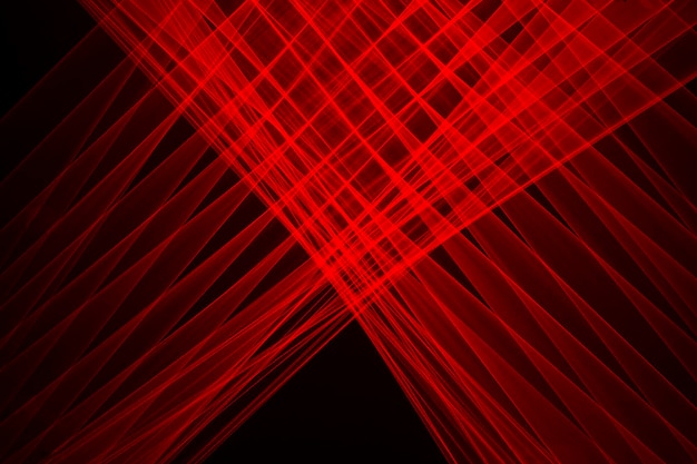 Abstract red lines drawn by light on a black background. Laser lines