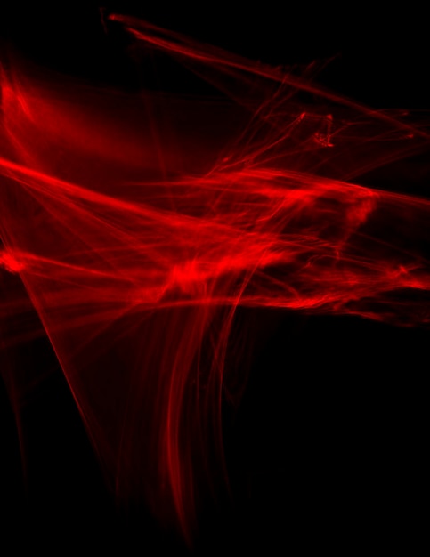 Abstract red lines drawn by light on a black background. Laser lines