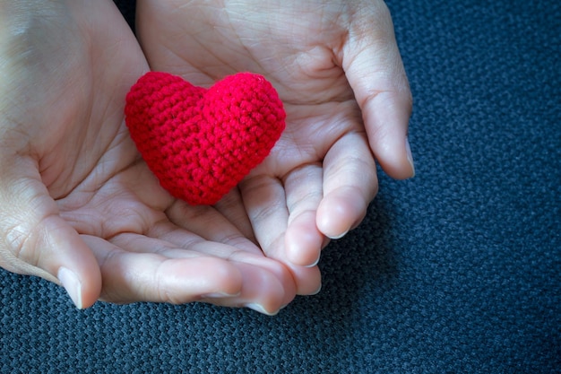 Abstract Red and Pink Heart Knitting in the hand for valentine 's day Love concept