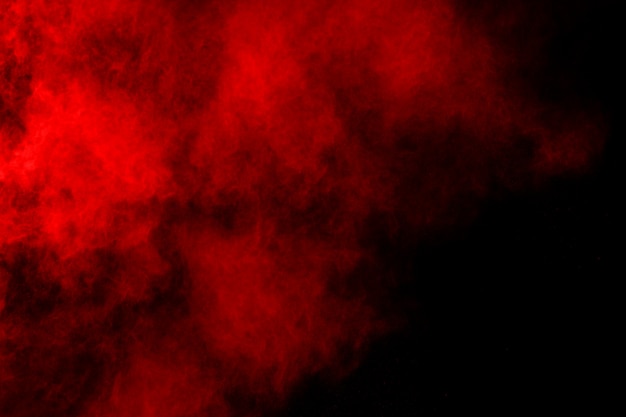 abstract red powder splatted on black background.  