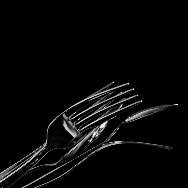 Abstract shapes with flatware on black background