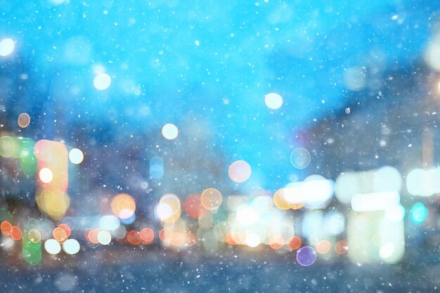 abstract snow blurred background city lights, winter holiday new year