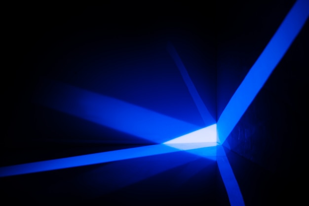 Abstract space with blue rays of light on the wall