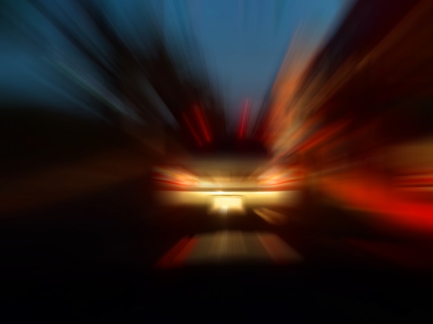 Abstract speed motion blur in city on night road neon light.