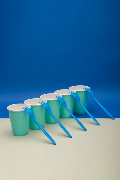 Abstract still life with blue forks and paper cups