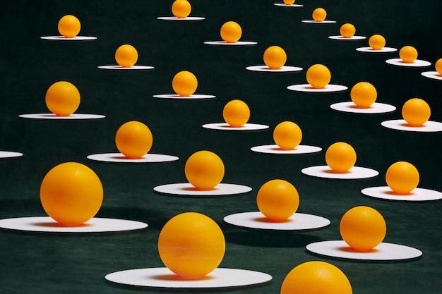 Abstract still life with orange balls on white sands suspended in the air