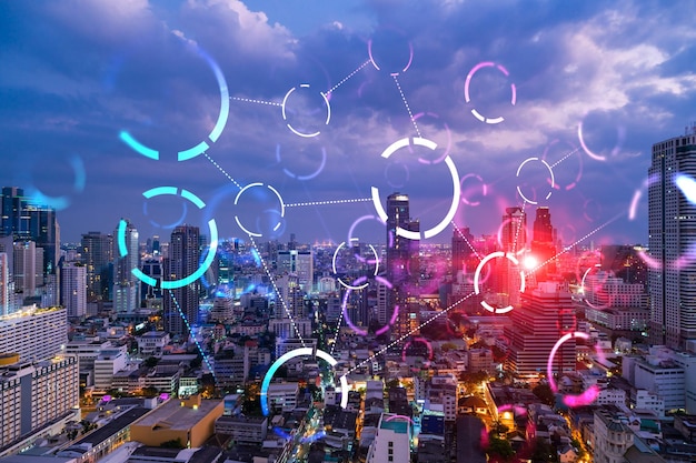 Abstract technology icons night aerial panoramic cityscape of Bangkok Asia The concept of innovative approach to optimize international business process Double exposure