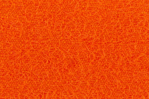 Abstract texture of the orange surface washcloths for washing dishes macro close-up 