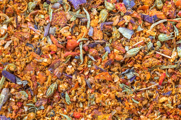 Abstract textured natural bright orange colorful copy space background. Millet, oat, different grains small particles, fish and parrot food.