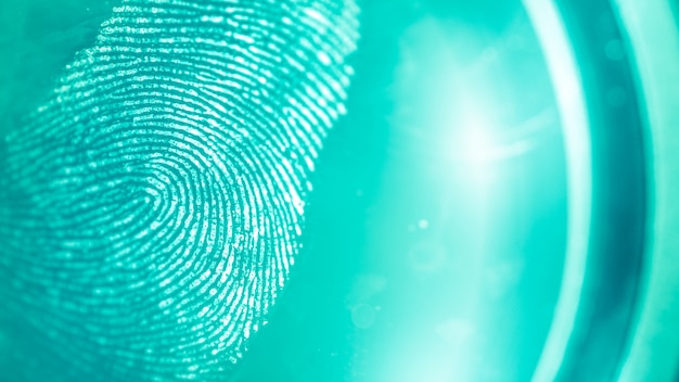 Abstract turquoise and green spots on a fingerprint, blurred background