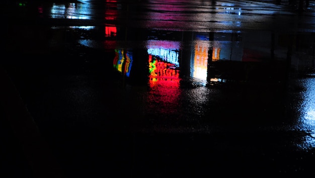 Abstract urban history, Lights and shadows, streets after rain with reflections on wet asphalt., horizontal image with blurred background, free space for text, defocus blurred