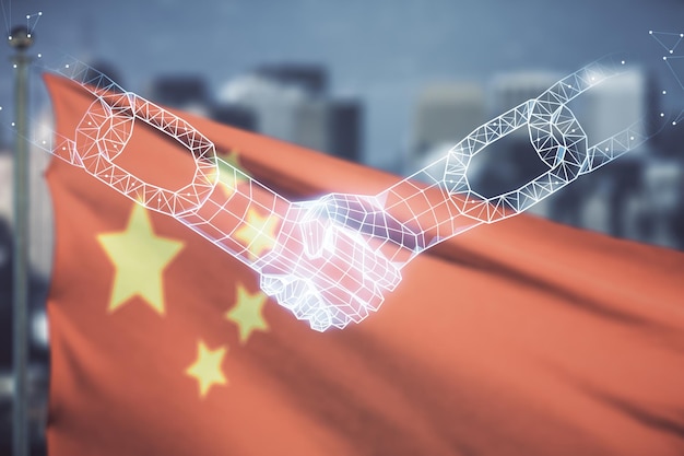 Abstract virtual blockchain technology hologram with handshake on flag of China and blurry skyscrapers background Digital money transfers and decentralization concept Multiexposure