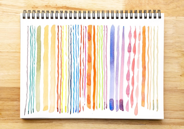 Abstract watercolor pattern background Colorful watercolor painted brush strokes on white notebook