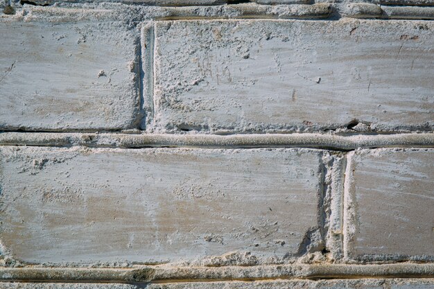 Abstract weathered texture stained old stucco light gray and aged paint white brick wall background