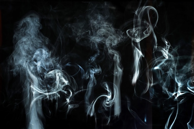 Abstract white smoke effect isolated on black background.