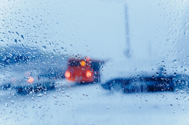 Abstract winter background. A street seen through glass with condensation droplets