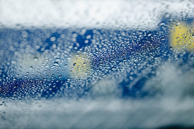 Abstract winter background. A street seen through glass with condensation droplets