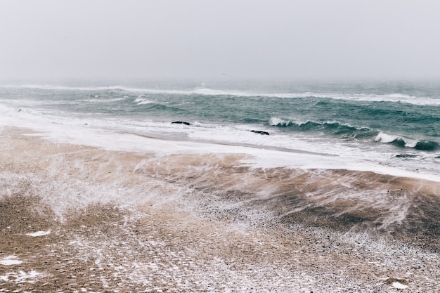 Abstract winter landscape of beach during a snowfall and wind