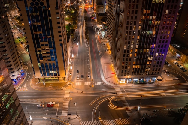 Abu Dhabi skyscrapers view, UAE. Magical streets of Abu Dhabi with tall glass buildings at night.