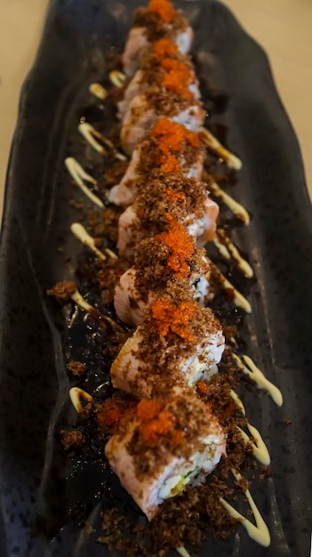 Aburi Salmon Roll consist of crab meat with soft shell crab sushi rice and rolled up After that the top is given aburi which is grilled fish meat that comes from a combination of salmon and tuna