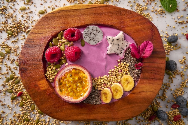 Acai bowl smoothie with passion fruit and raspberries