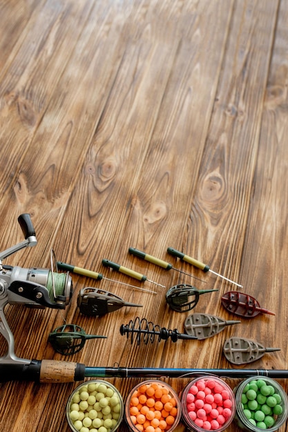 Accessories for carp fishing and fishing baits on wooden planks with copy space