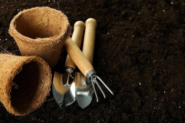 Accessories and tools for gardening on soil background