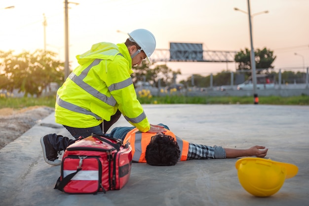 Accident at work of construction labor people, Basic First aid and CPR Training at outdoor.