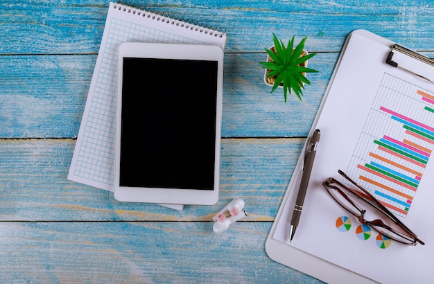 Accountants work analyzing financial reports on a digital tablet in a wireless headphone and glasses