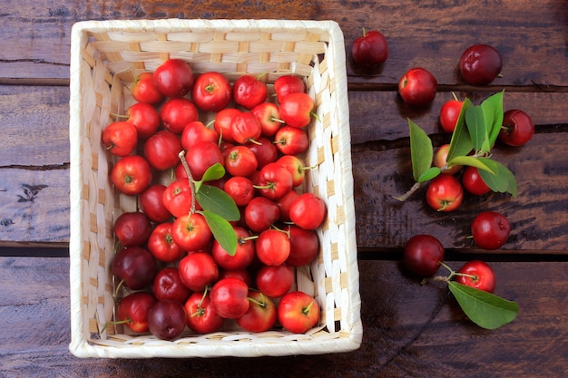 Acerola Cherry raw, fresh, box on rustic wooden table, antioxidant fruits