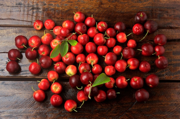 Acerola Cherry raw, fresh, on rustic wooden table, High vitamin C and antioxidant fruits