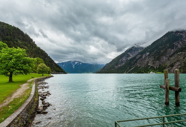 Achensee ( Lake Achen) summer landscape with  green meadow and wooden moorage (Austria)