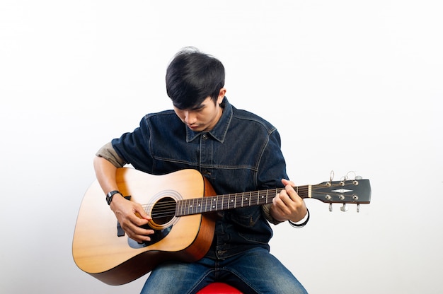 acoustic guitarist is holding the guitar. And playing guitar Concepts of hobbies and relaxation in free time for good quality of life