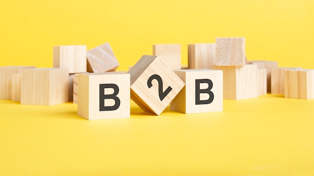 Acronym B2B business to business wooden cubes with letters on yellow background business concept image