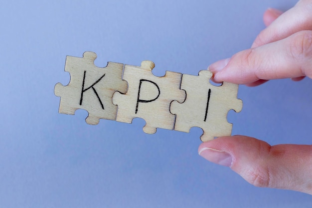 The acronym KPI which stands for Key Performance Indicator The letters written on the puzzles