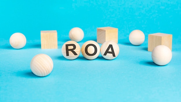 Acronym roa on wooden balls bright blue background