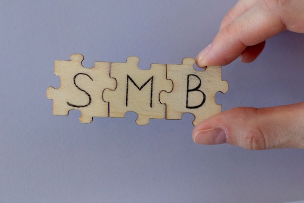 Photo the acronym smb which stands for small and mediumsized business the letters written on the puzzles