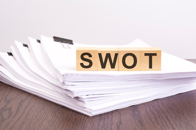 Acronym SWOT on wooden cubes business analysis concept